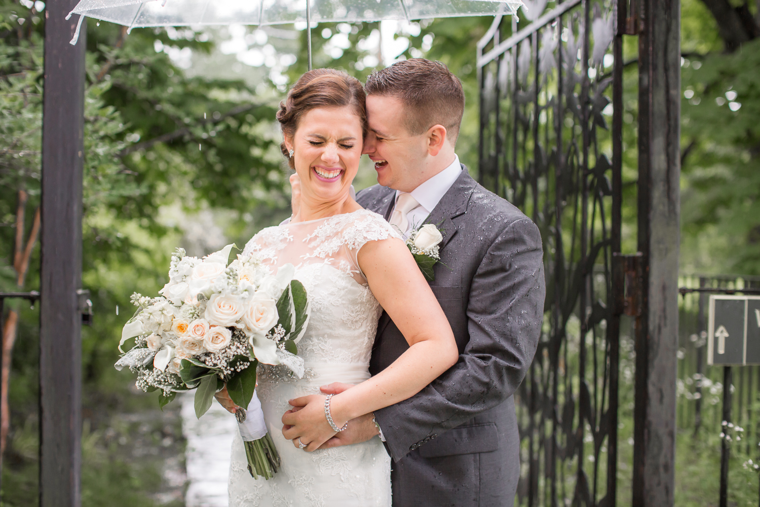 Couple laughing under an umbrella