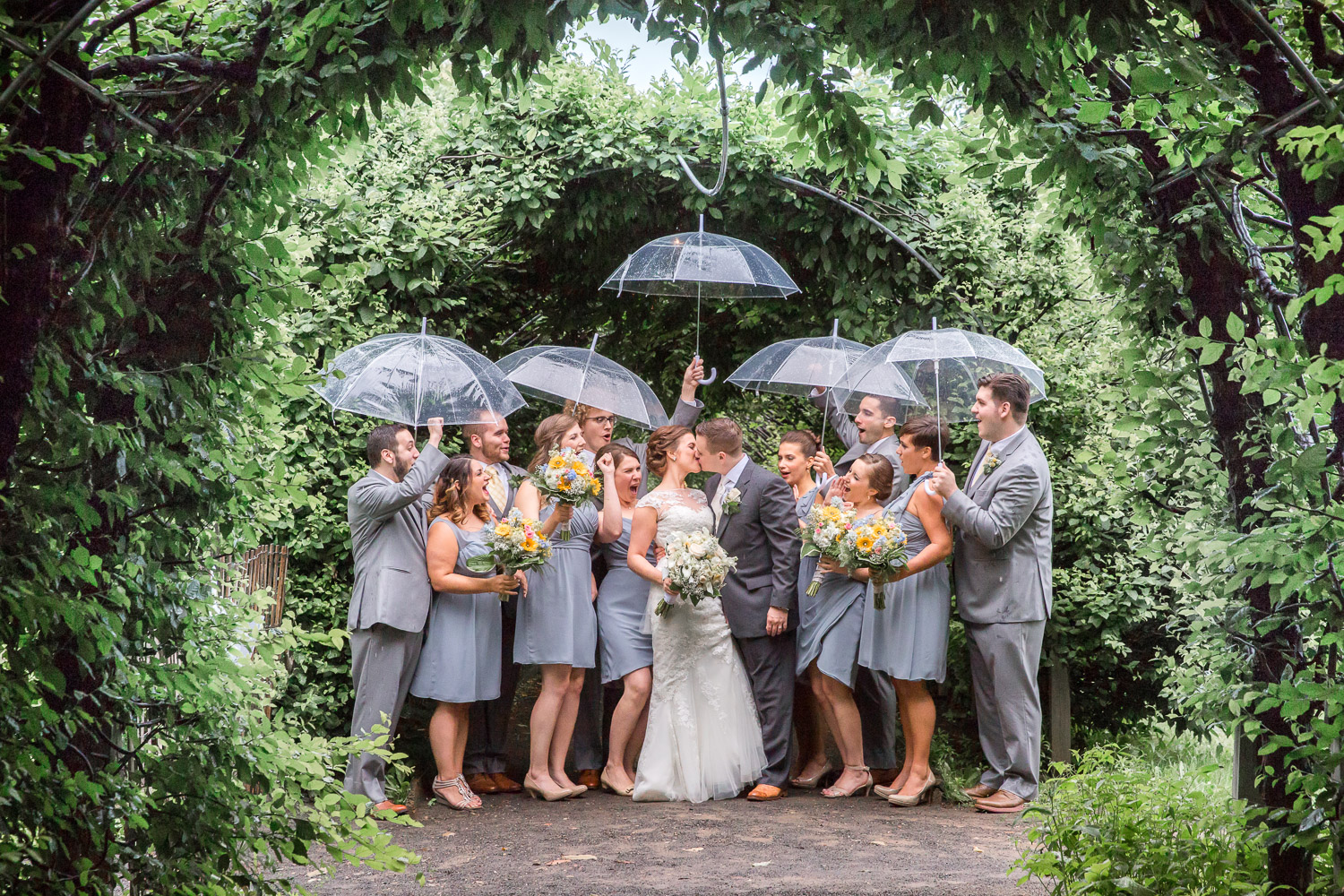 Bridal party cheering for couple on a rainy day