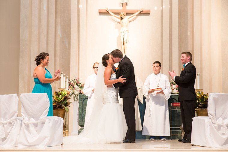 Bride and groom first kiss at St. Robert Bellarmine