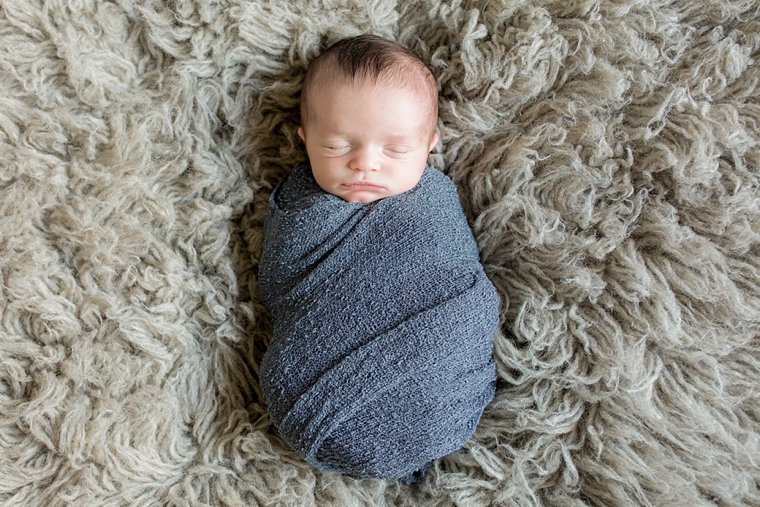 Baby boy on gray flokati fur