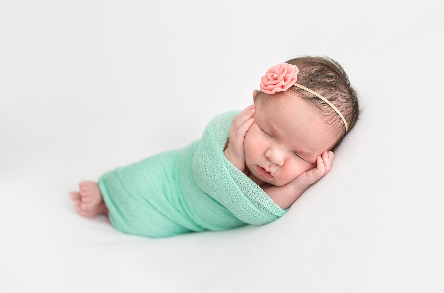 photo of newborn girl in mint green and coral