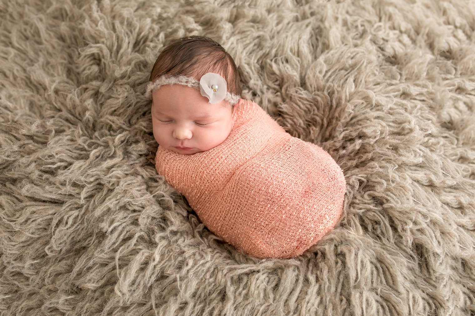 Newborn on gray flokati