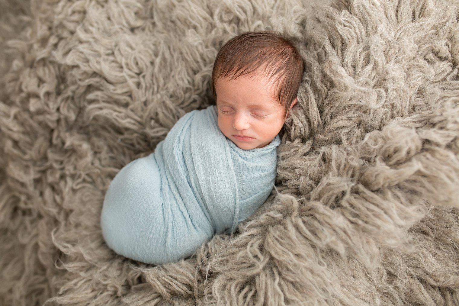 Sleepy newborn baby boy photo