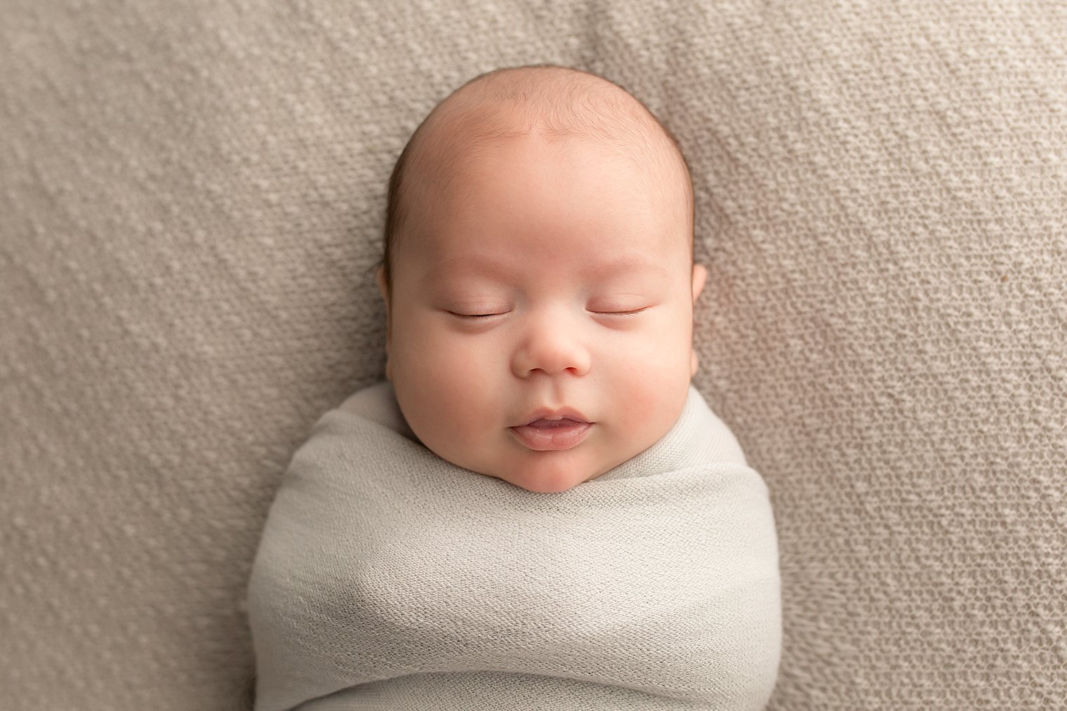 Central NJ Newborn Photographers baby on gray blanket photo