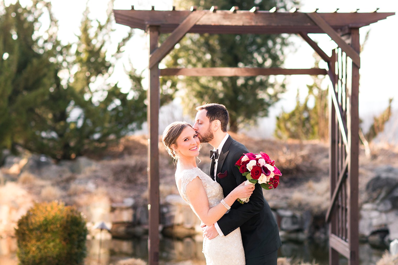 Grand Cascades Lodge Wedding Photos of bride and groom kissing