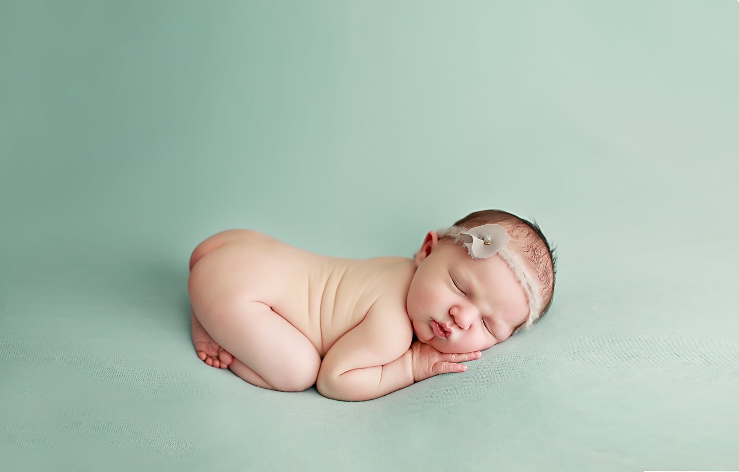 photo of newborn baby girl on aqua blanket