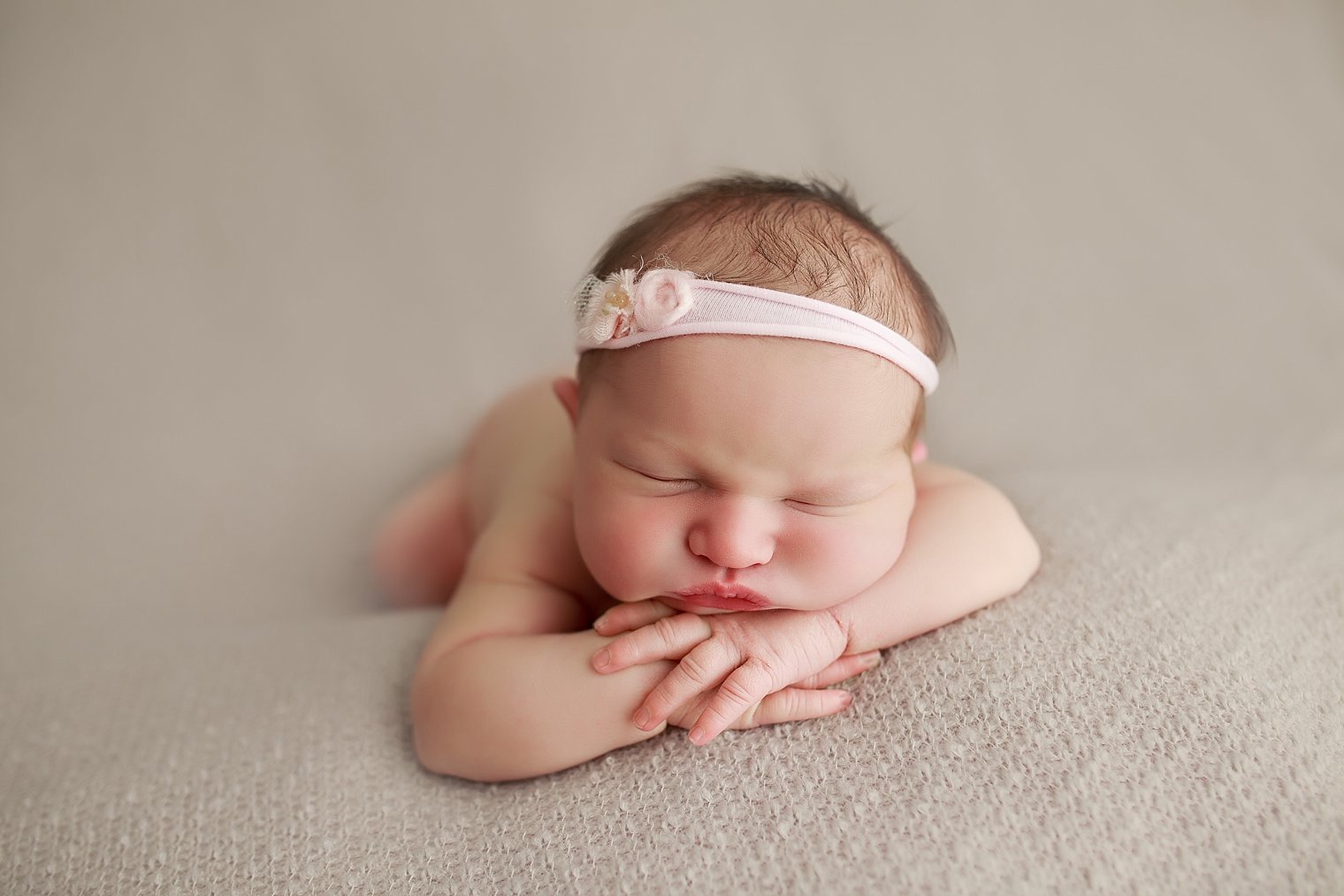 newborn baby with pink headband