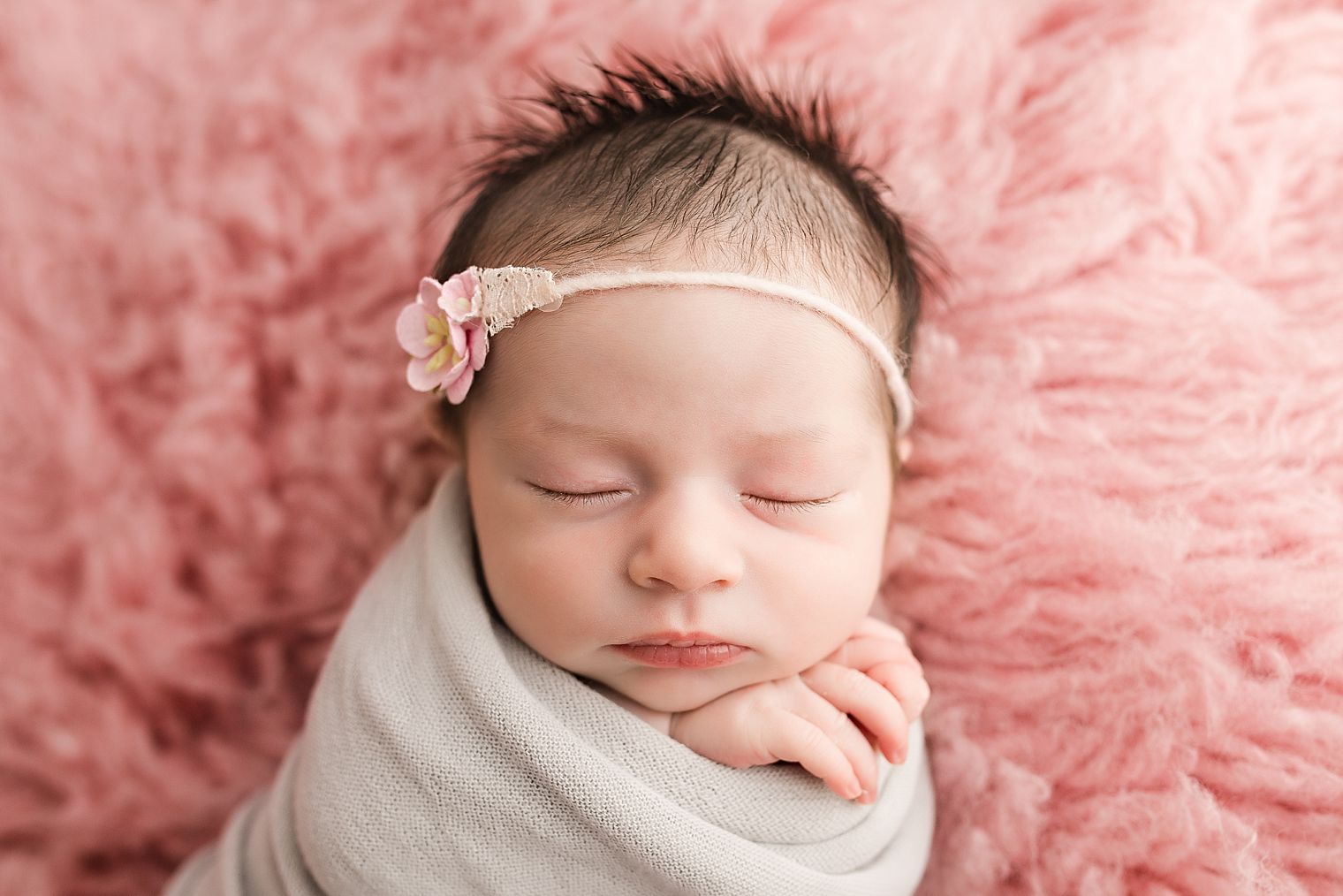 Newborn girl in pink and gray