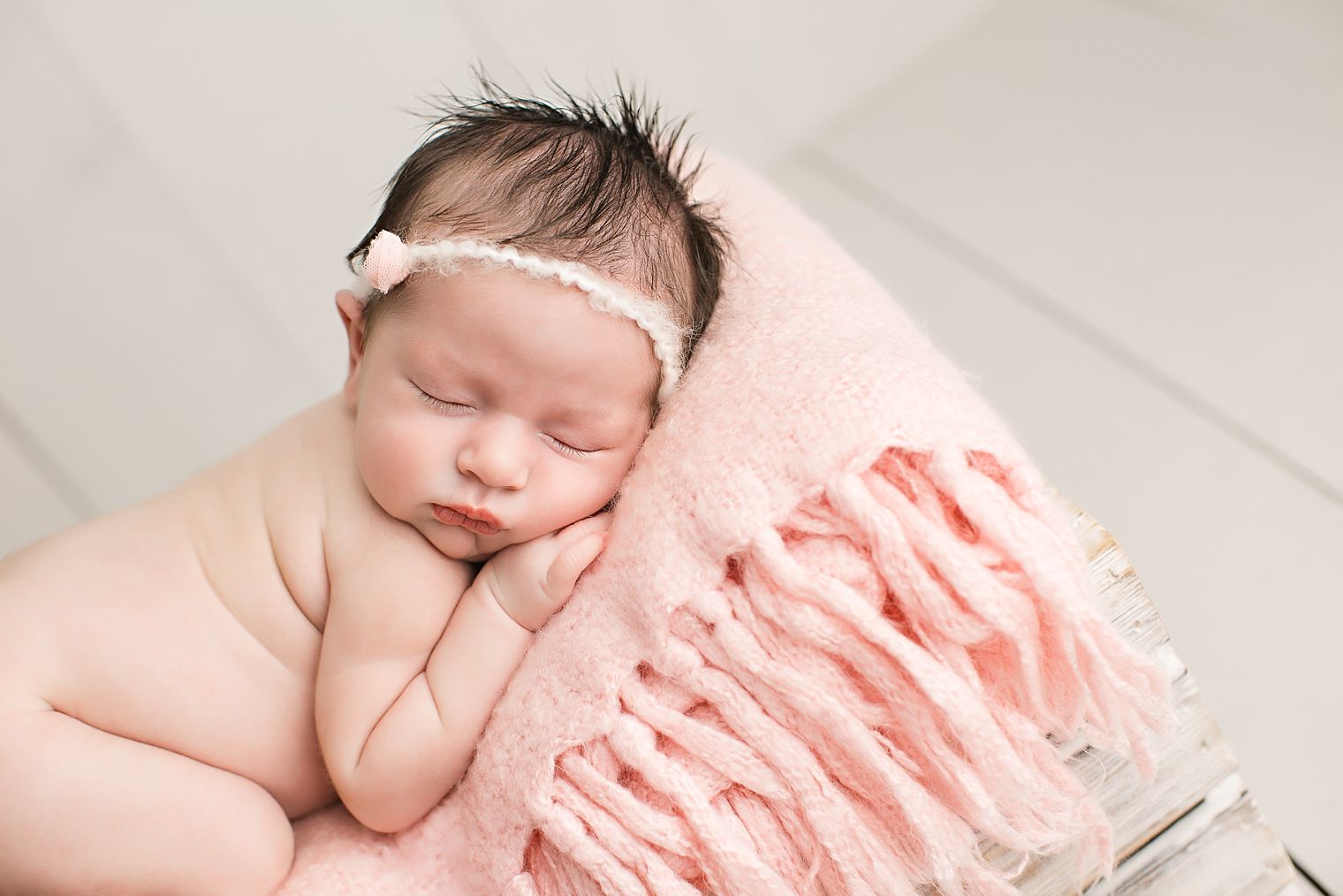 Newborn in pink and gray color palette
