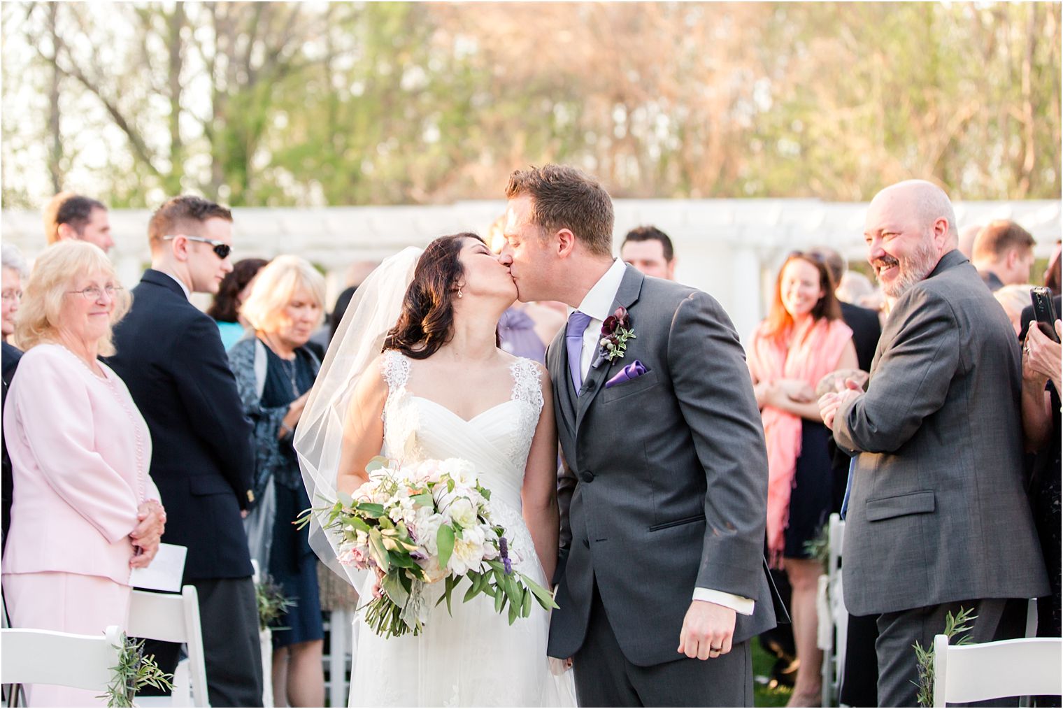 Bride and groom kiss during recessional