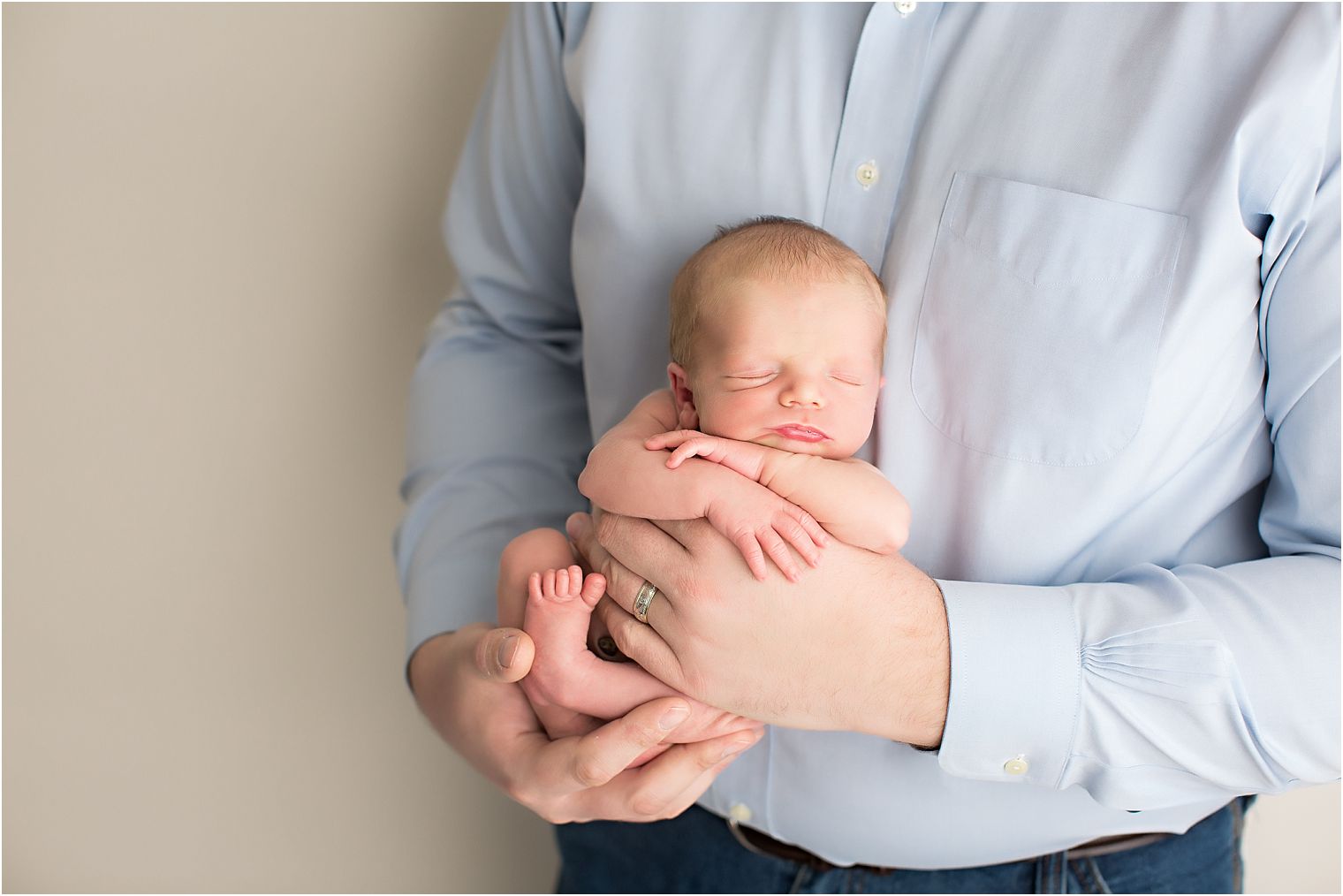 Baby boy in father's hands