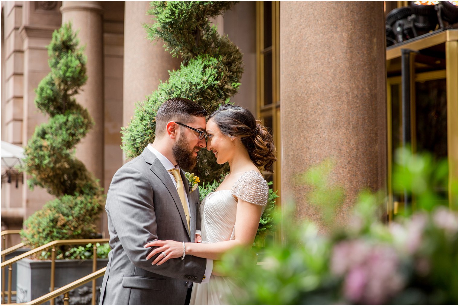 Bride and groom in front of New York Palace Hotel