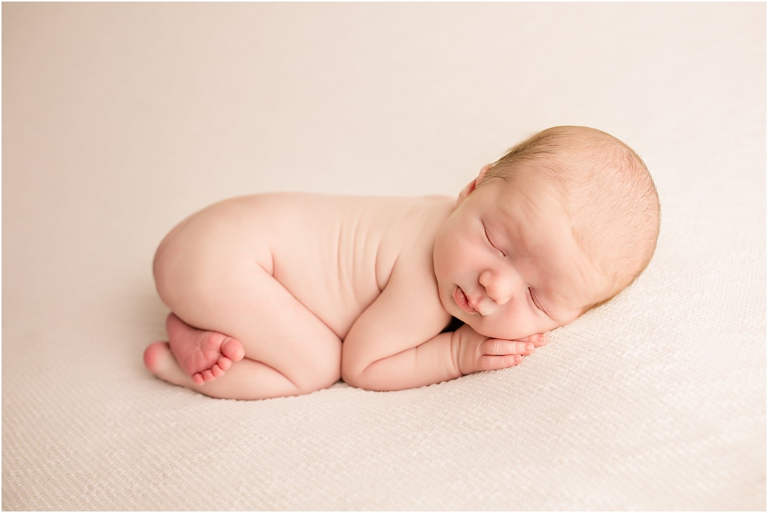 Newborn in tushie up pose