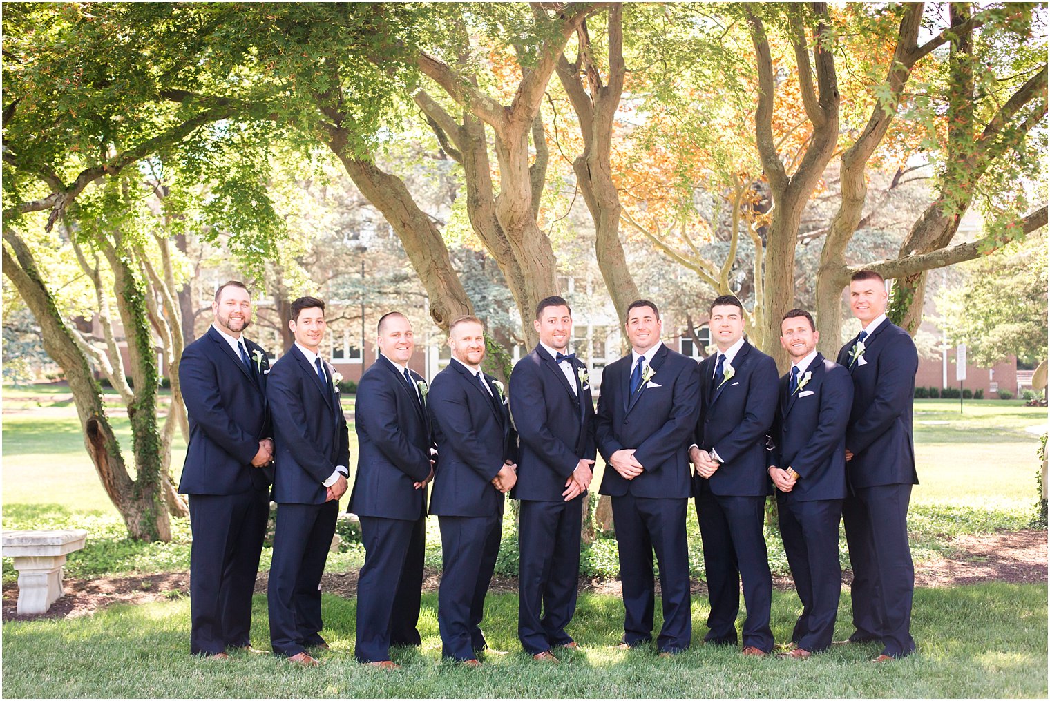 Groomsmen in navy suits by Men's Wearhouse