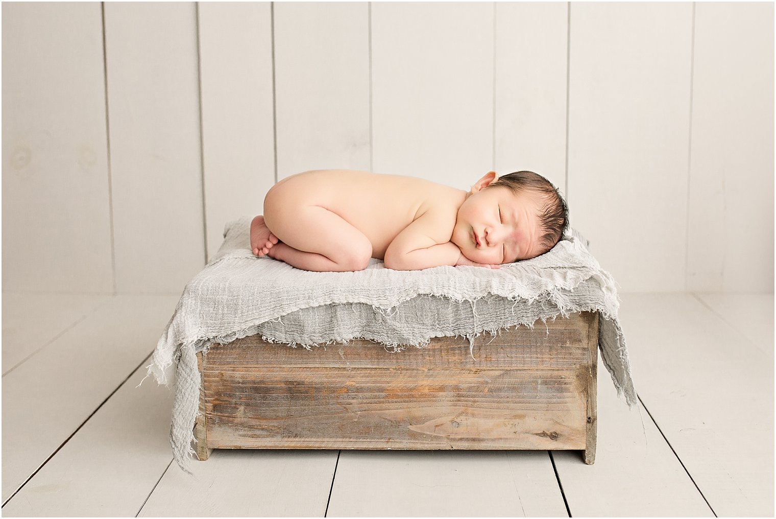 Baby boy on wooden crate