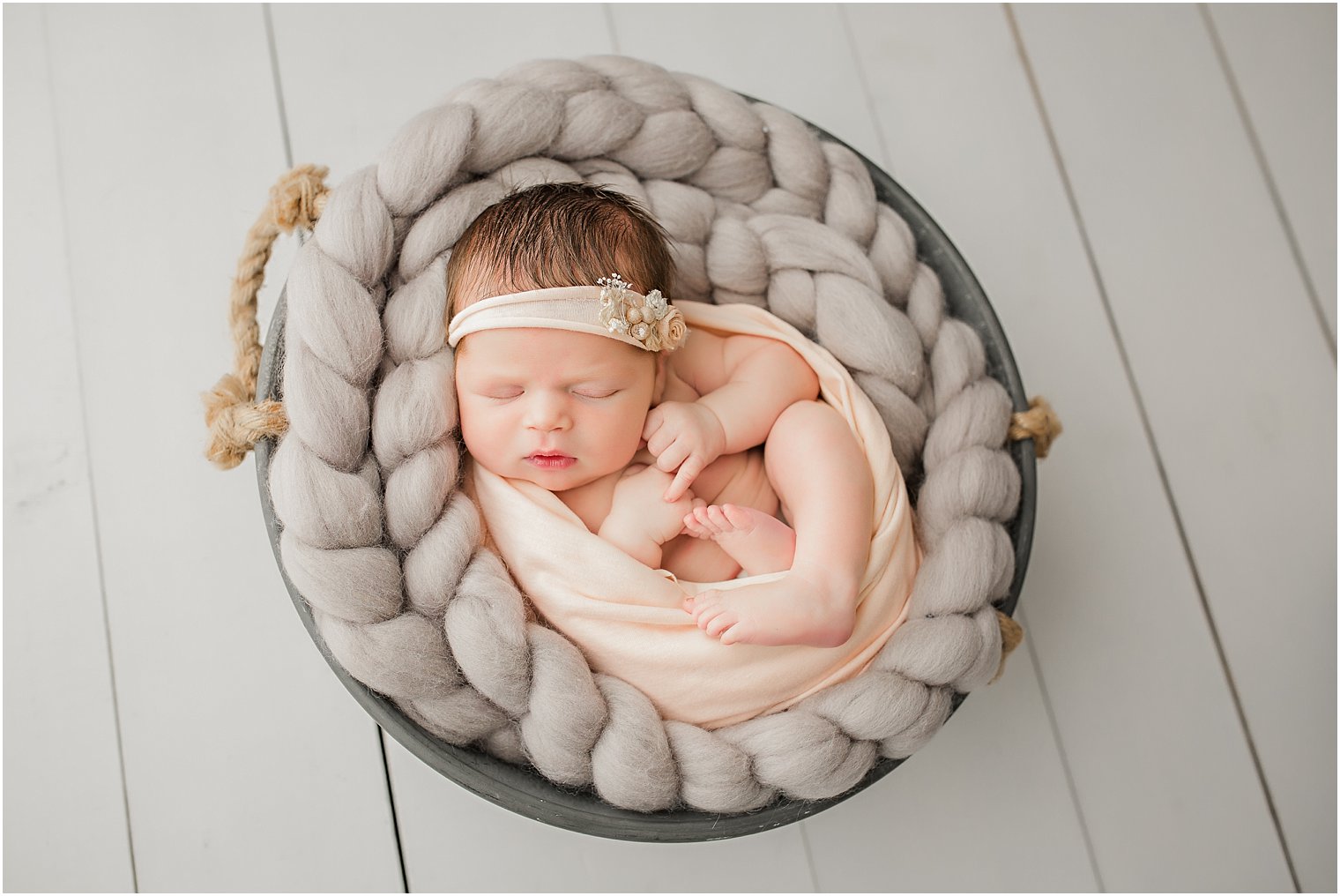 Newborn girl in gray and coral pink