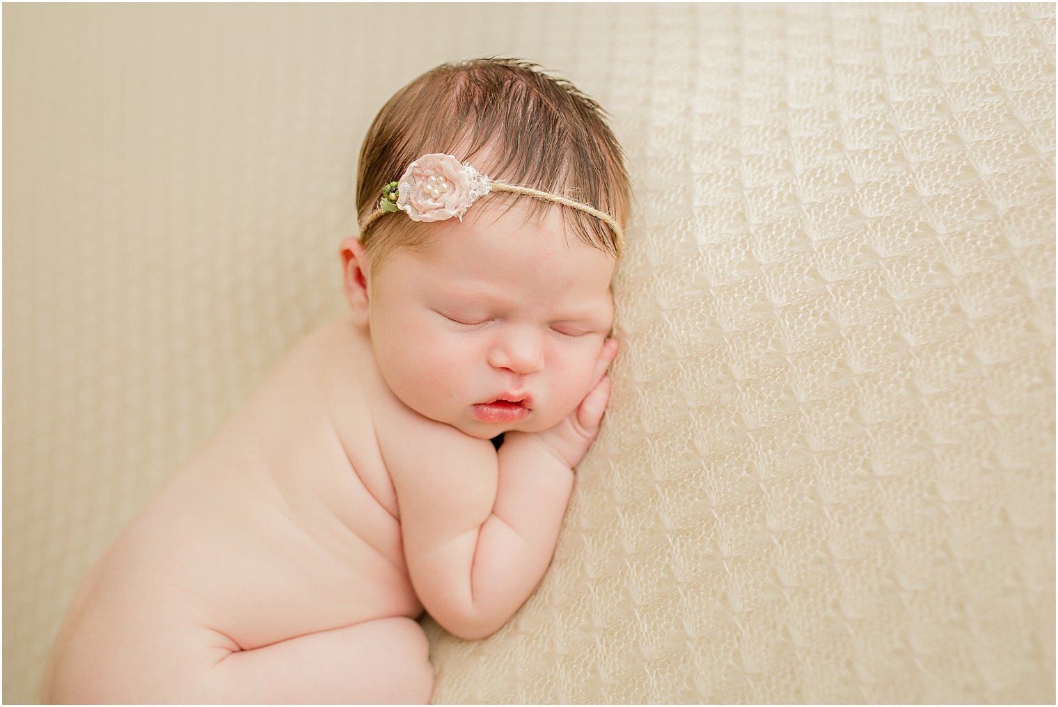 Newborn girl in beige and pink