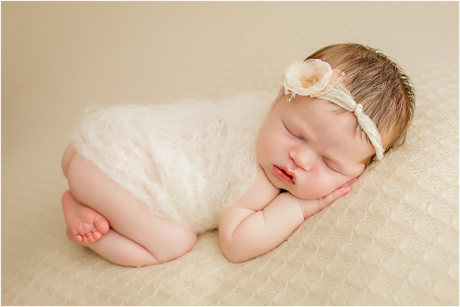 Newborn on beige blanket 