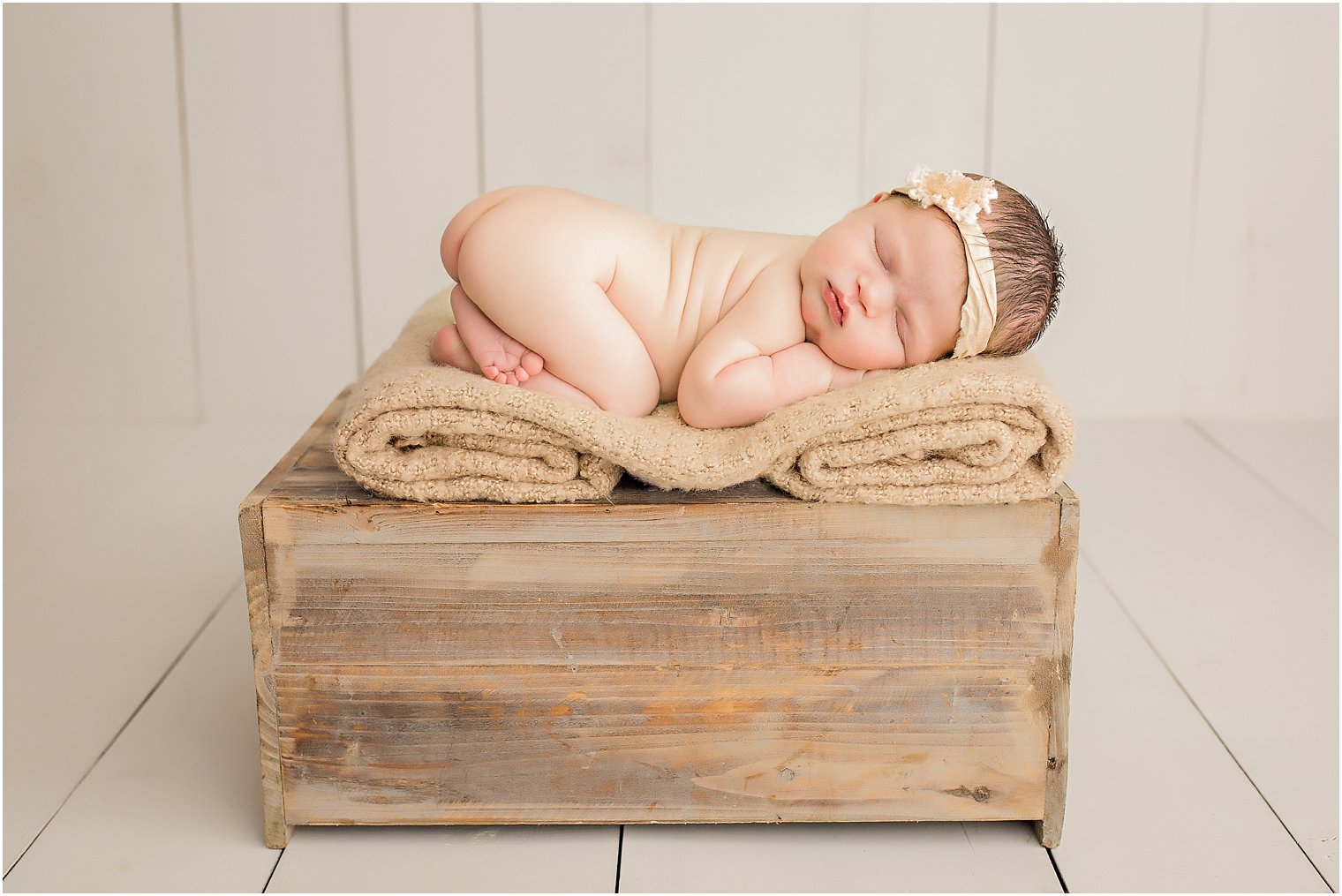 Tushie up pose on wooden crate