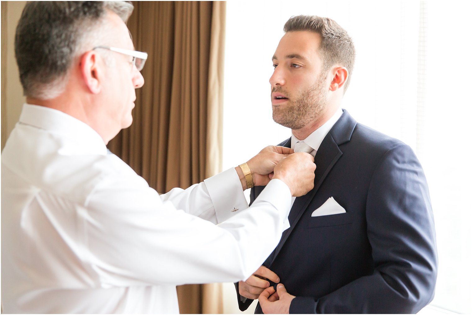 Groom getting ready with his father