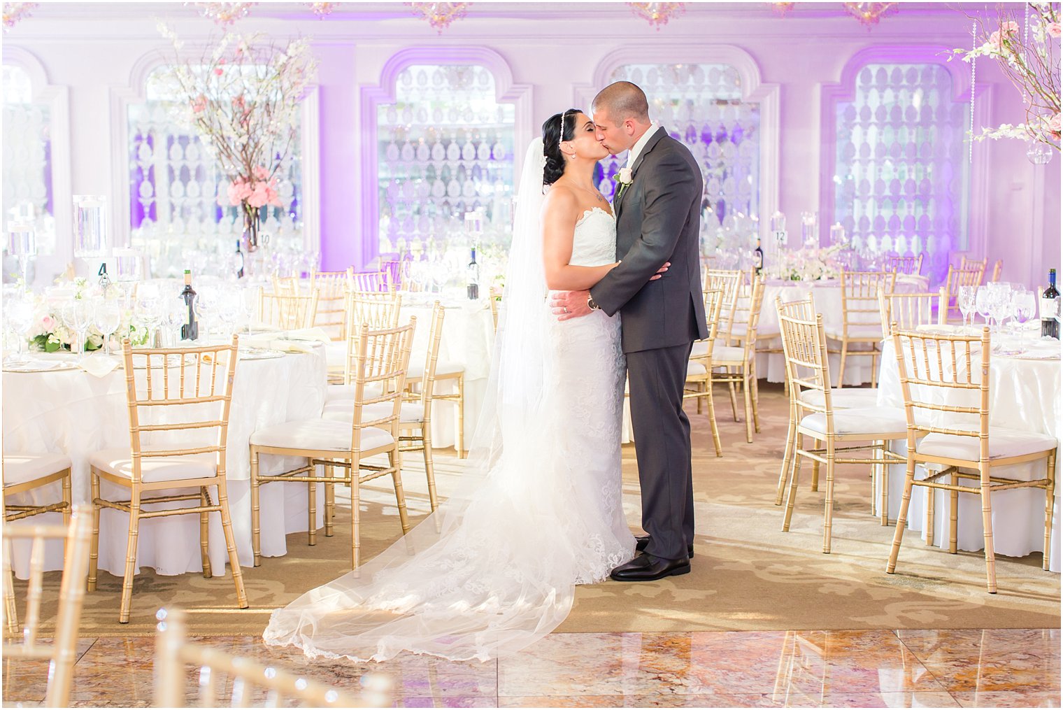 Bride and groom in empty ballroom