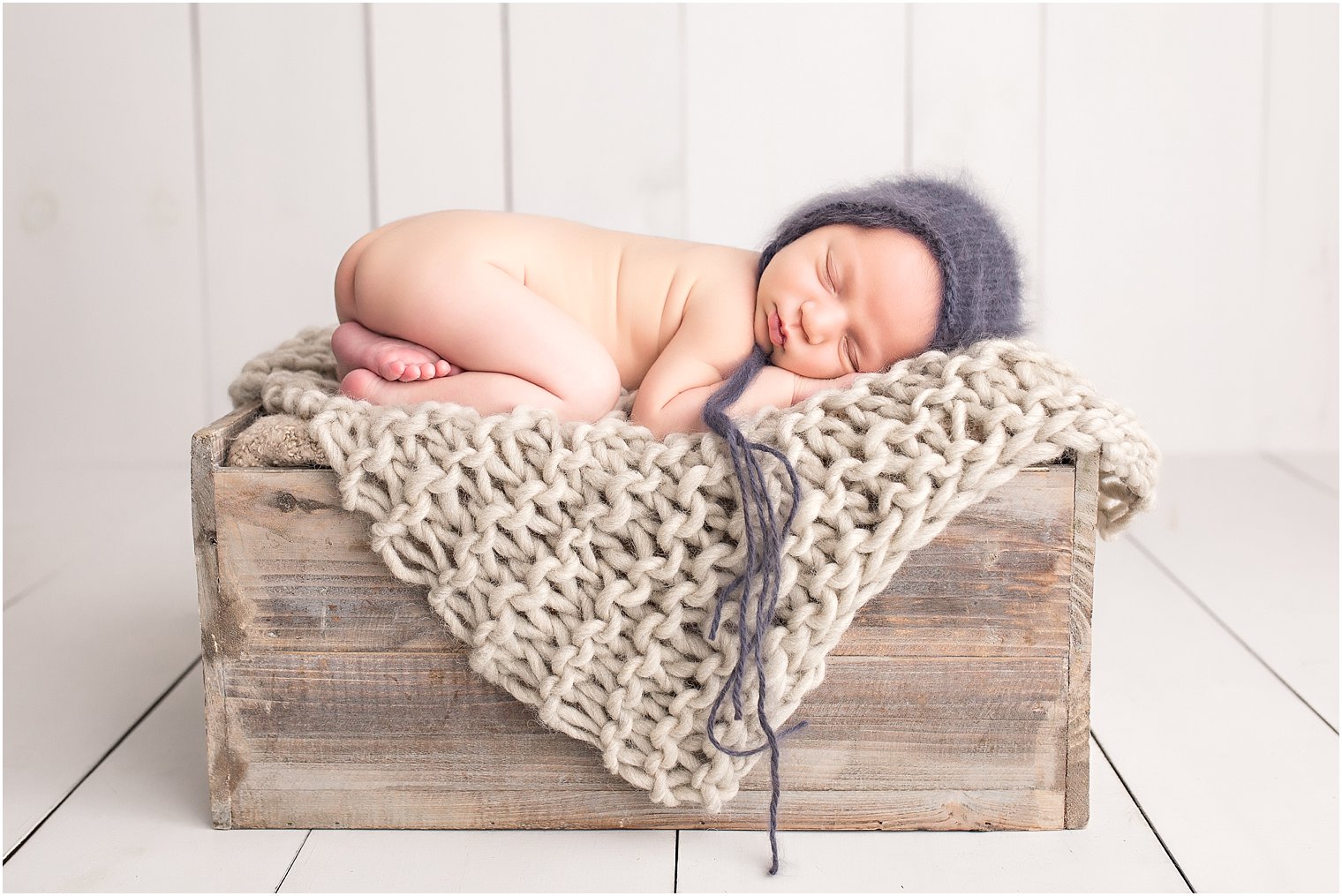 Newborn boy on crate