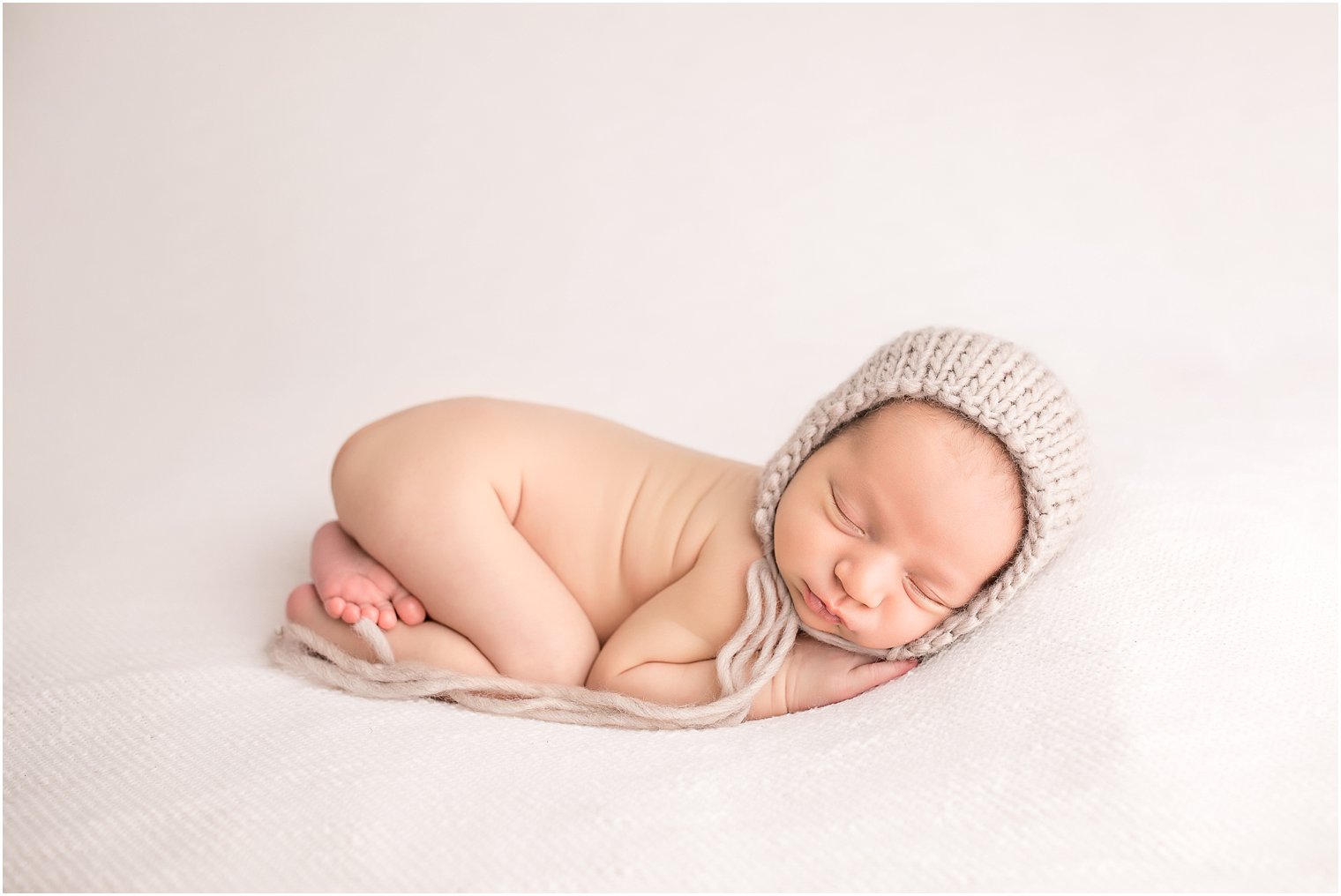 Newborn boy in tushie up pose