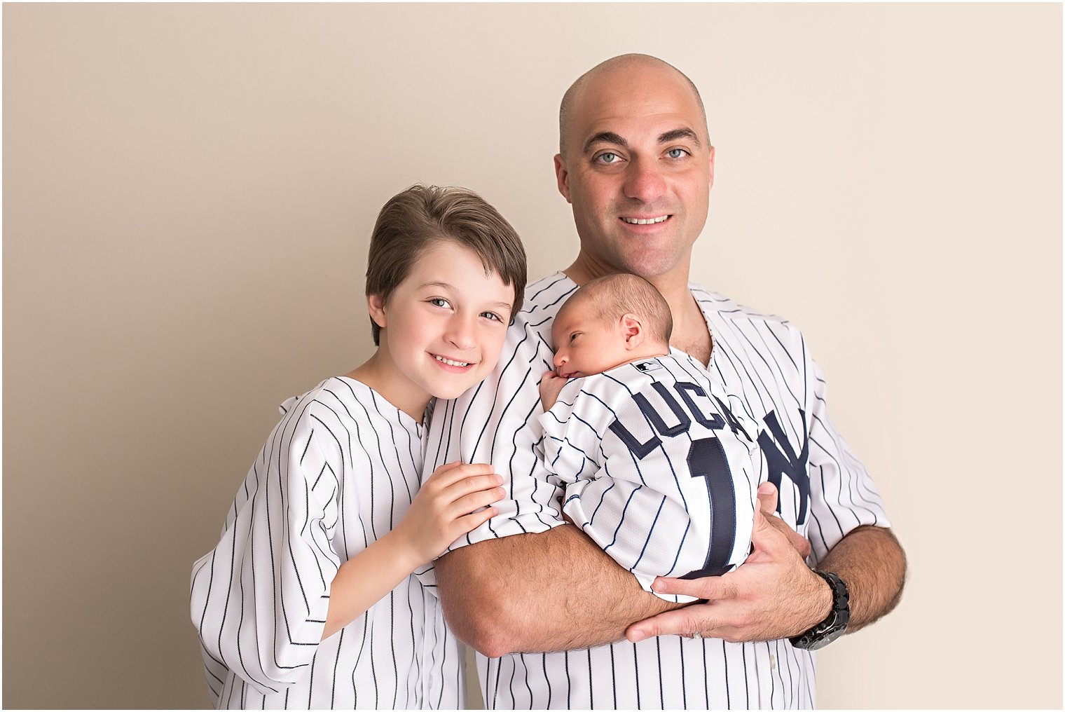 Father and sons in Yankee shirts during newborn session