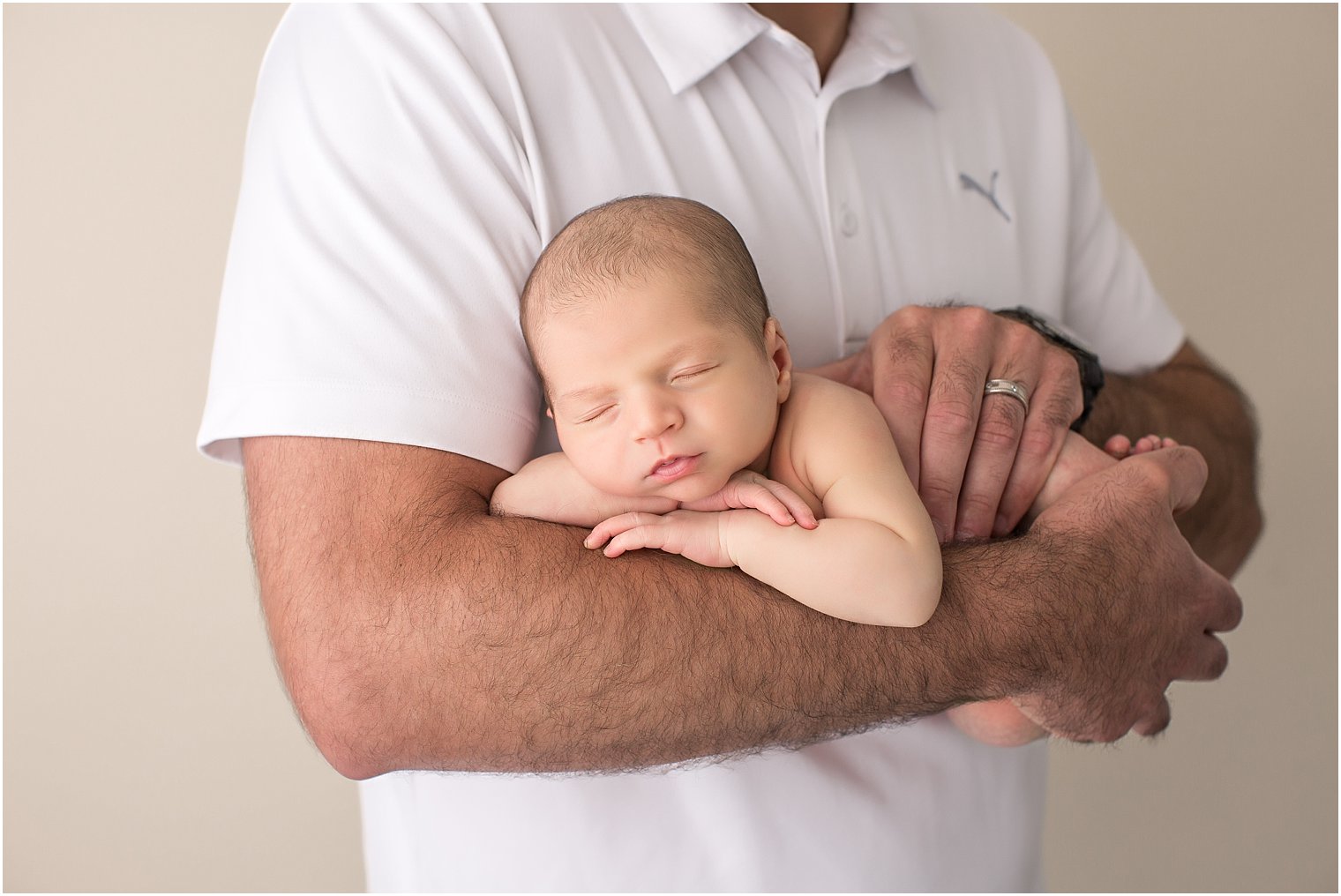 Newborn boy in father's arms