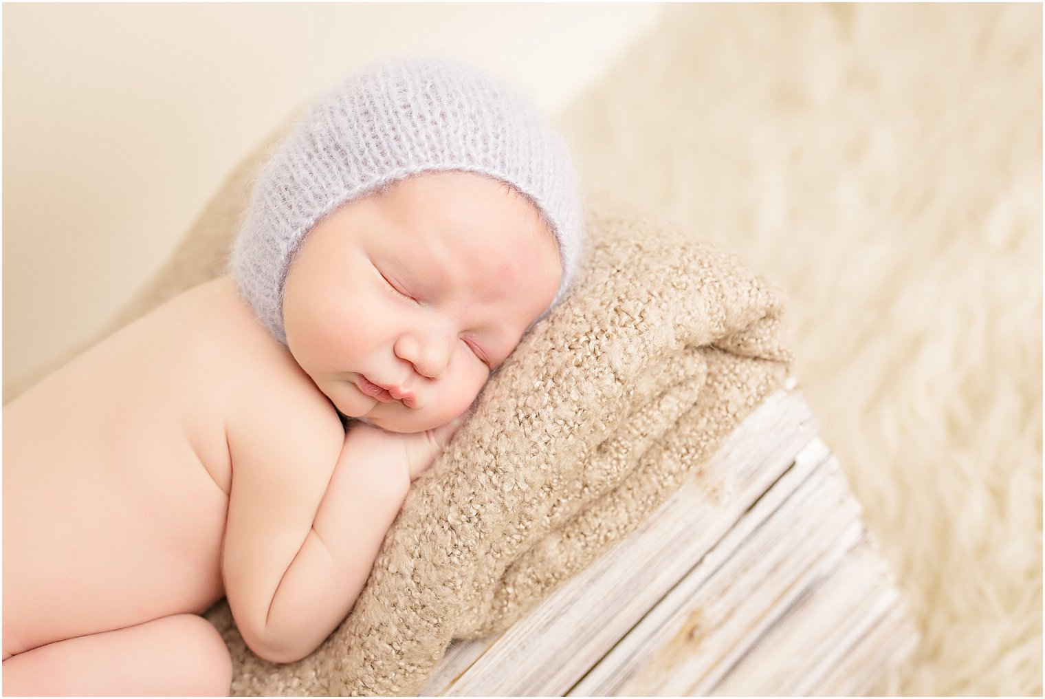 Newborn boy on crate