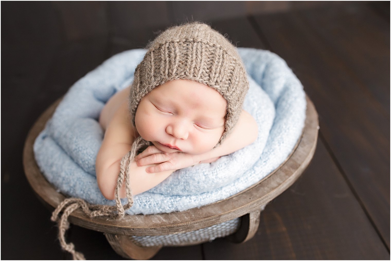 Baby boy in wood bowl