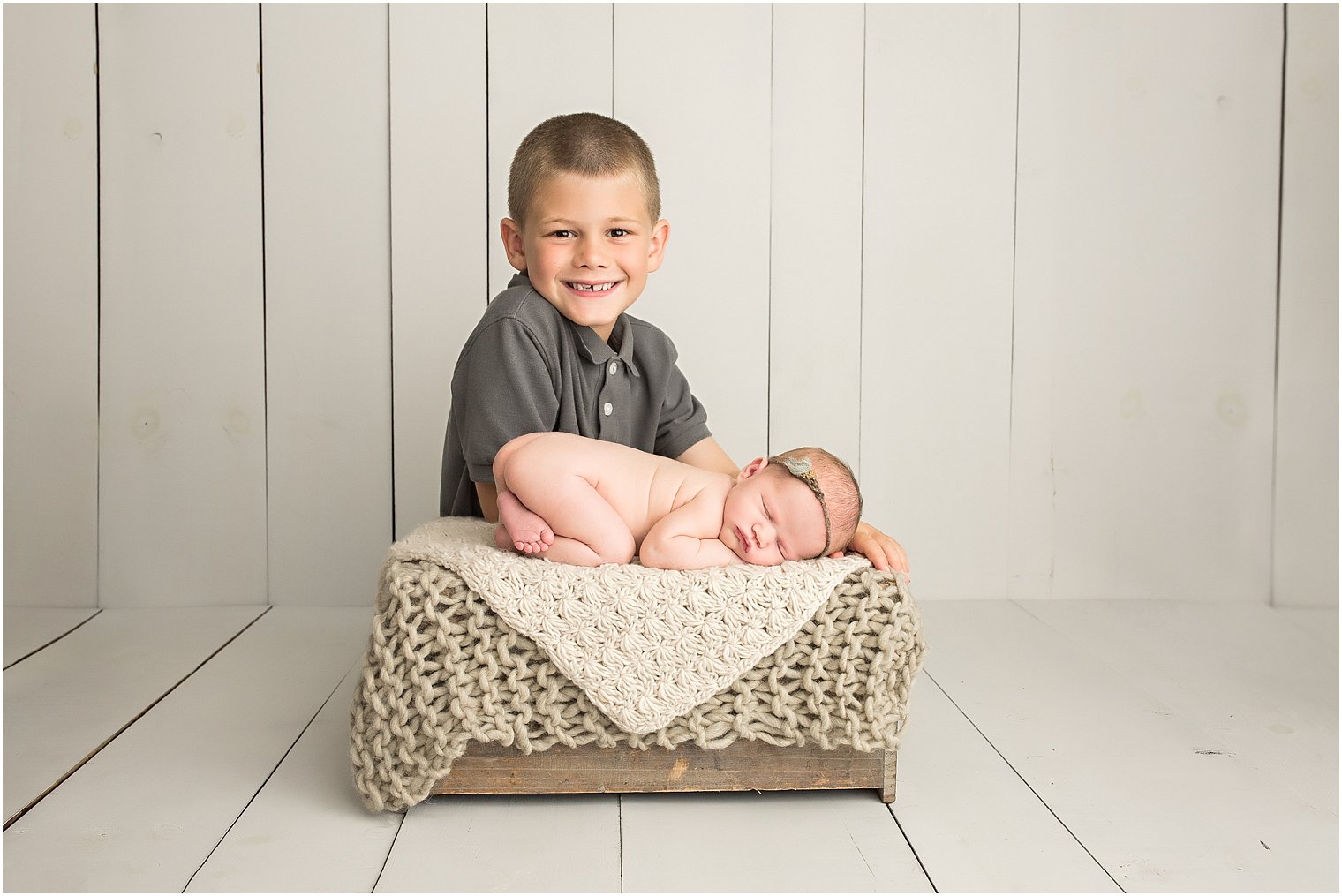 Newborn boy with his baby sister