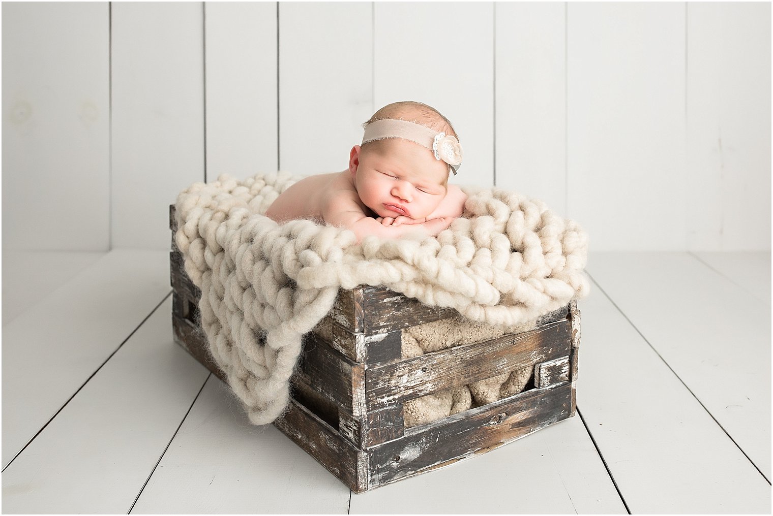 Newborn girl on a crate