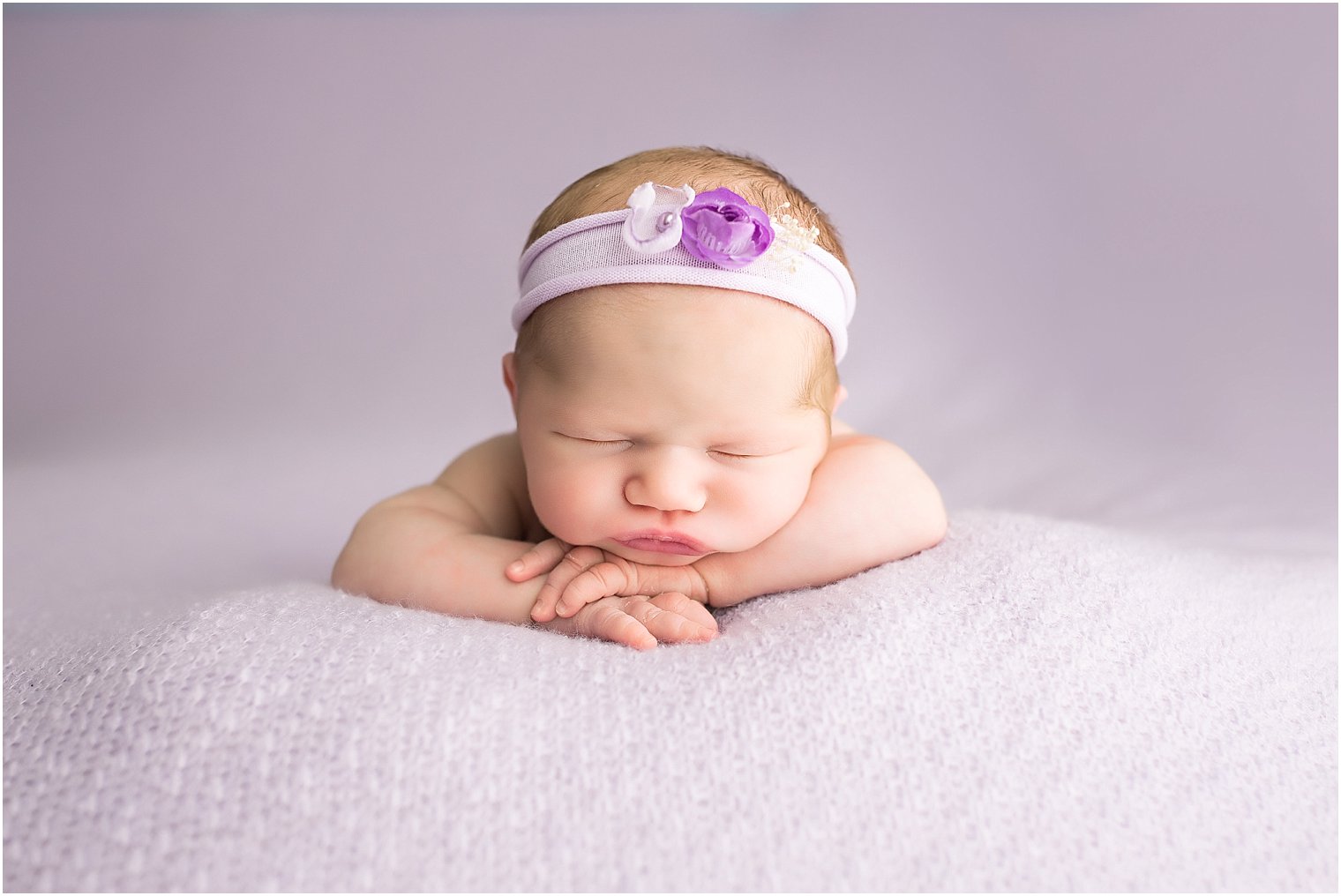 Newborn girl in purple