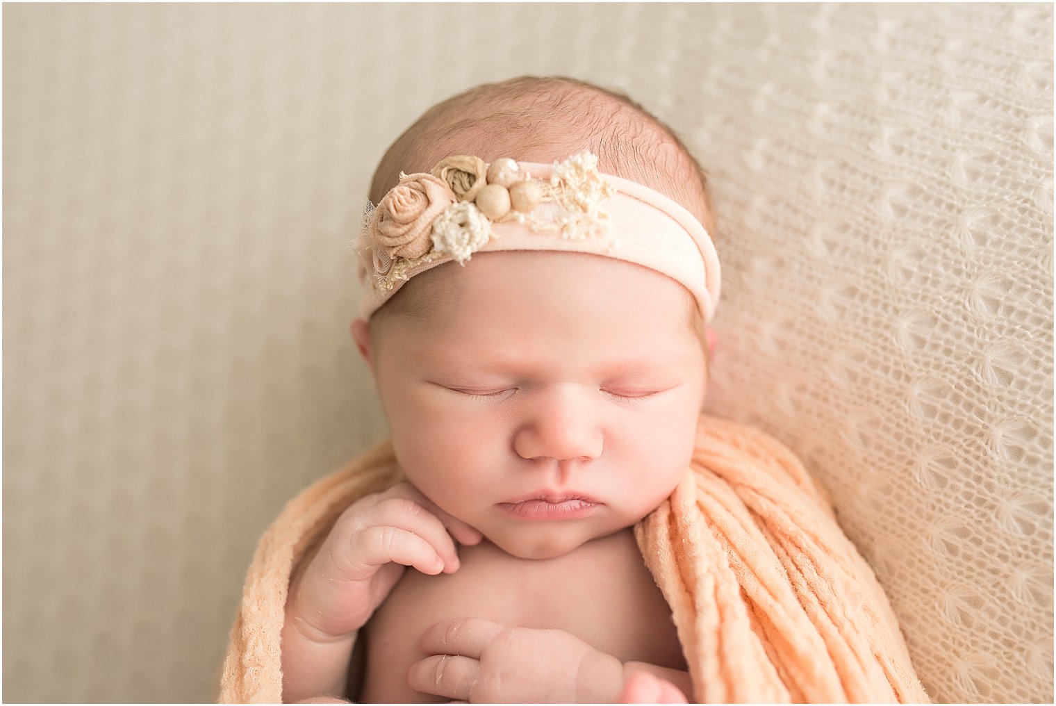 Newborn girl in peach headband