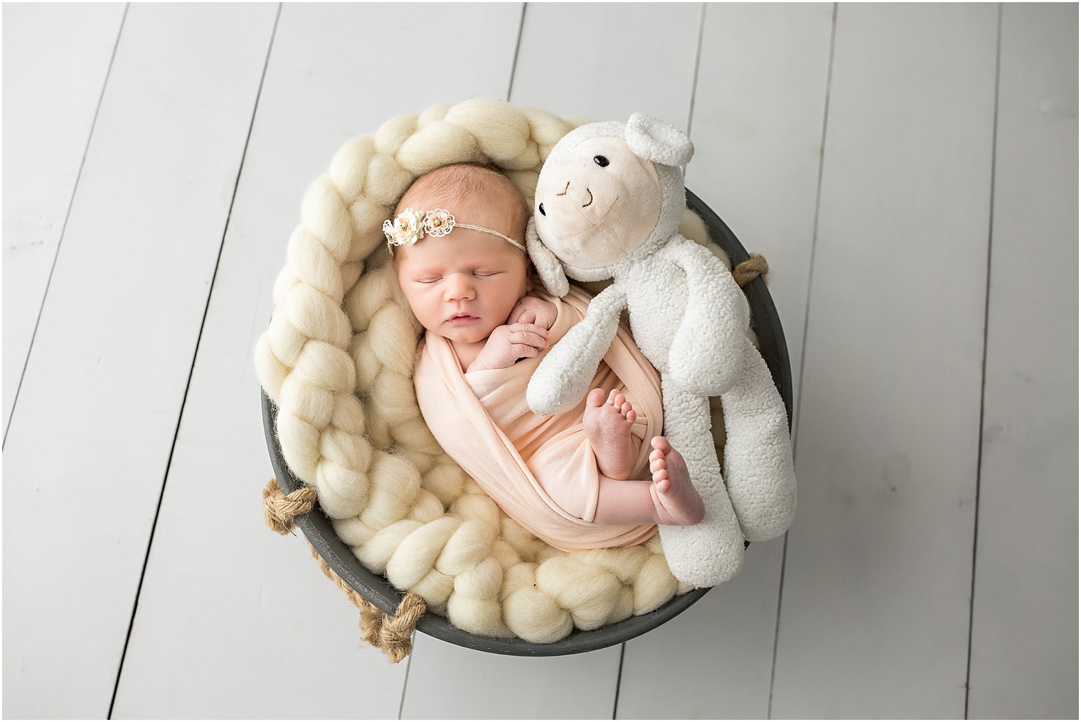 Newborn baby girl with stuffed animal