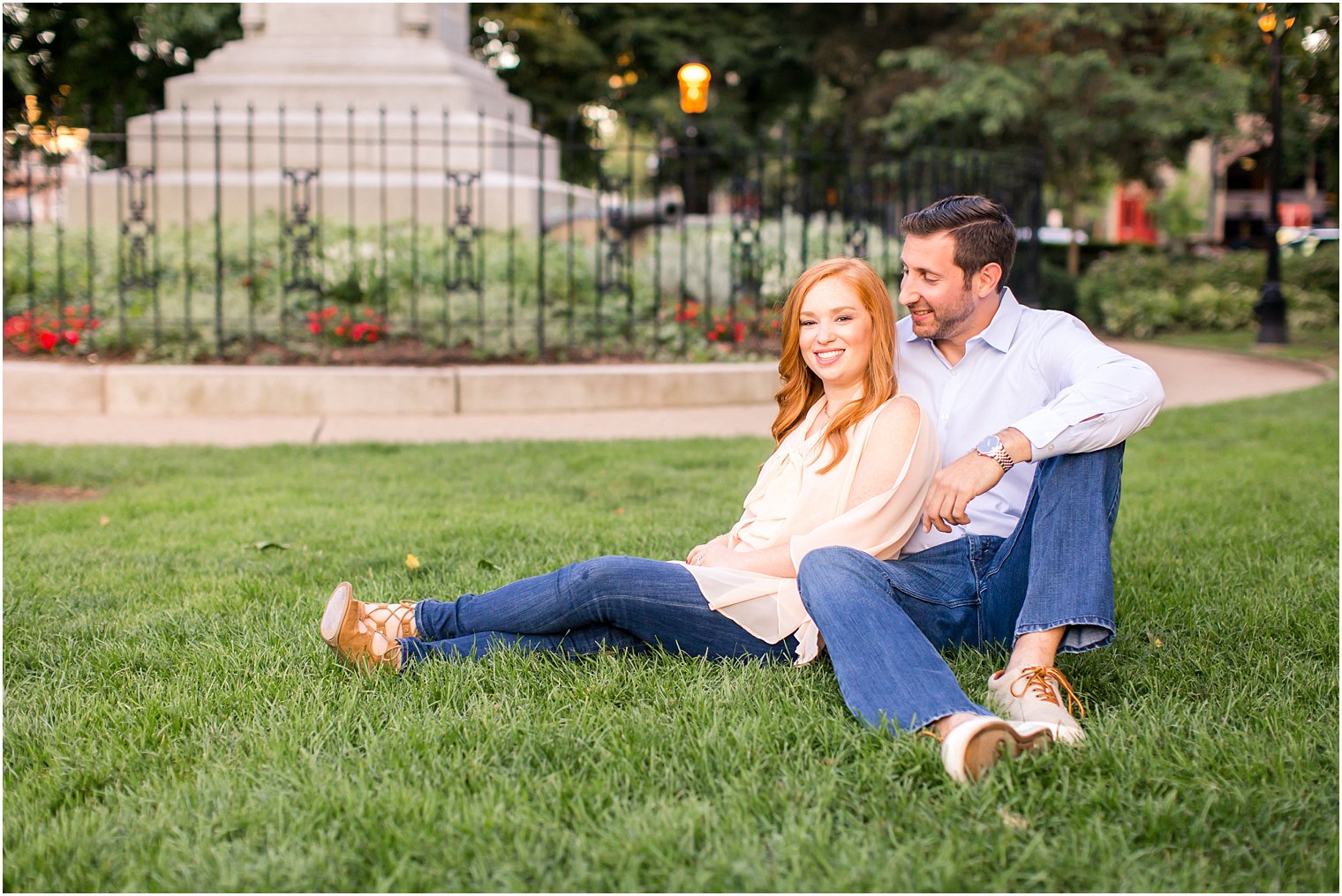 Bride and groom sitting on grass