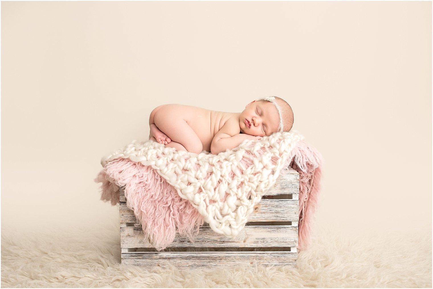Baby girl on wooden crate