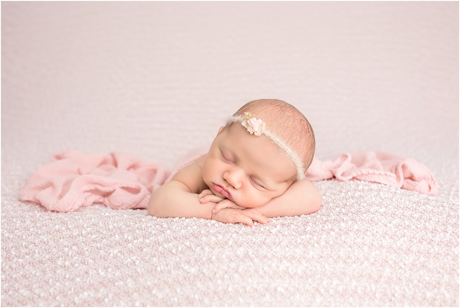 Newborn in chin on hands pose