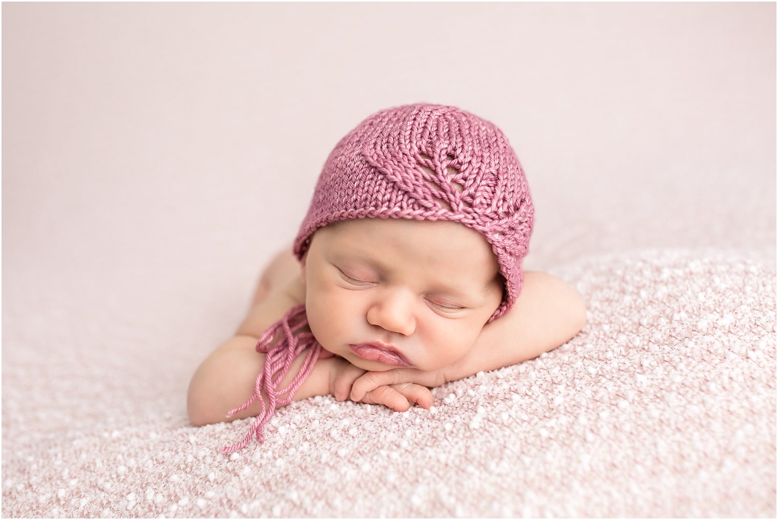 Newborn in mauve hat