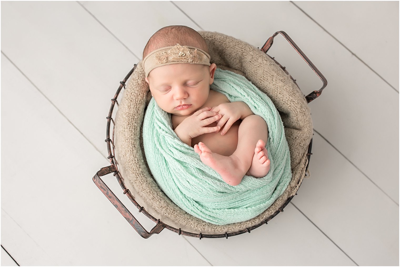 Newborn in wire basket
