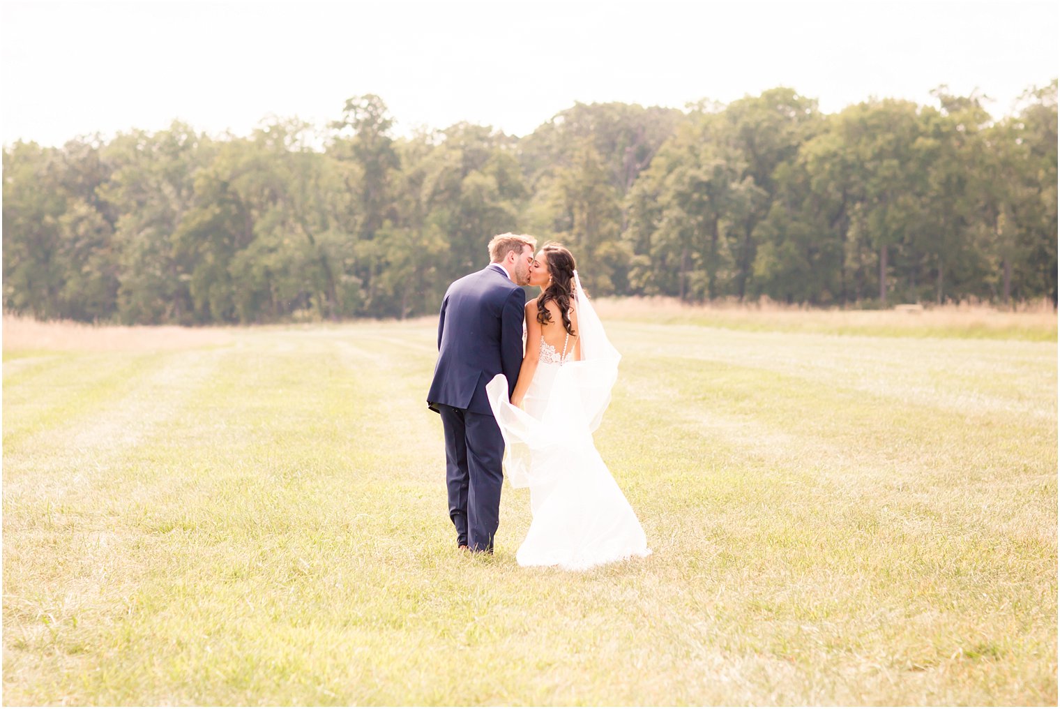 Bride and groom in open field