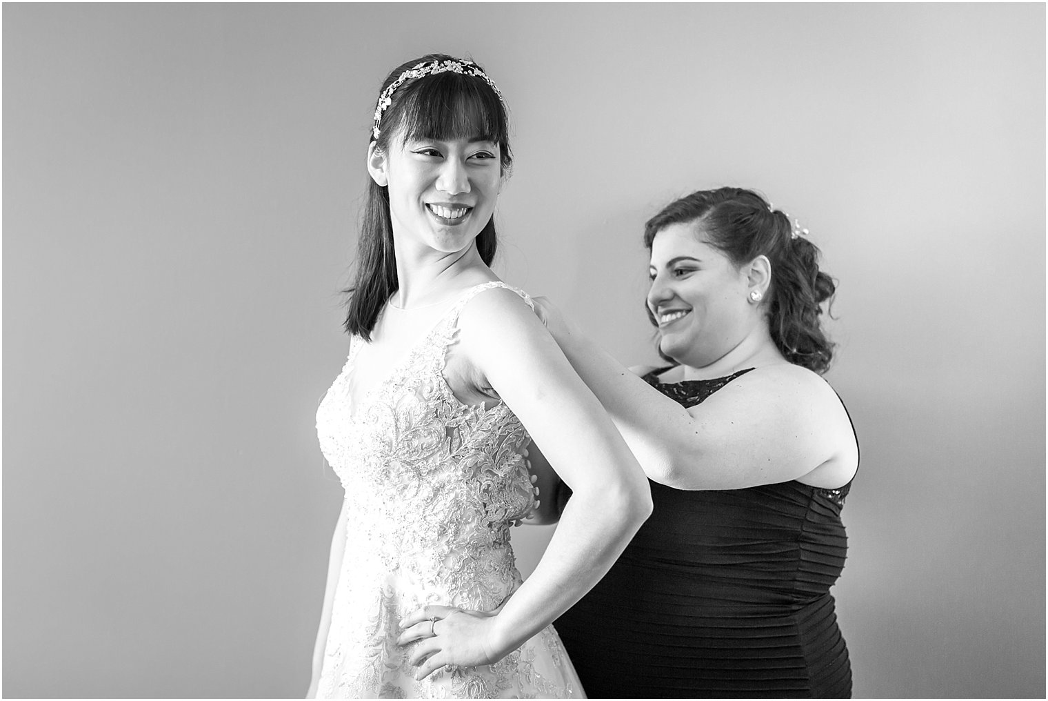 Bride getting ready with bridesmaid