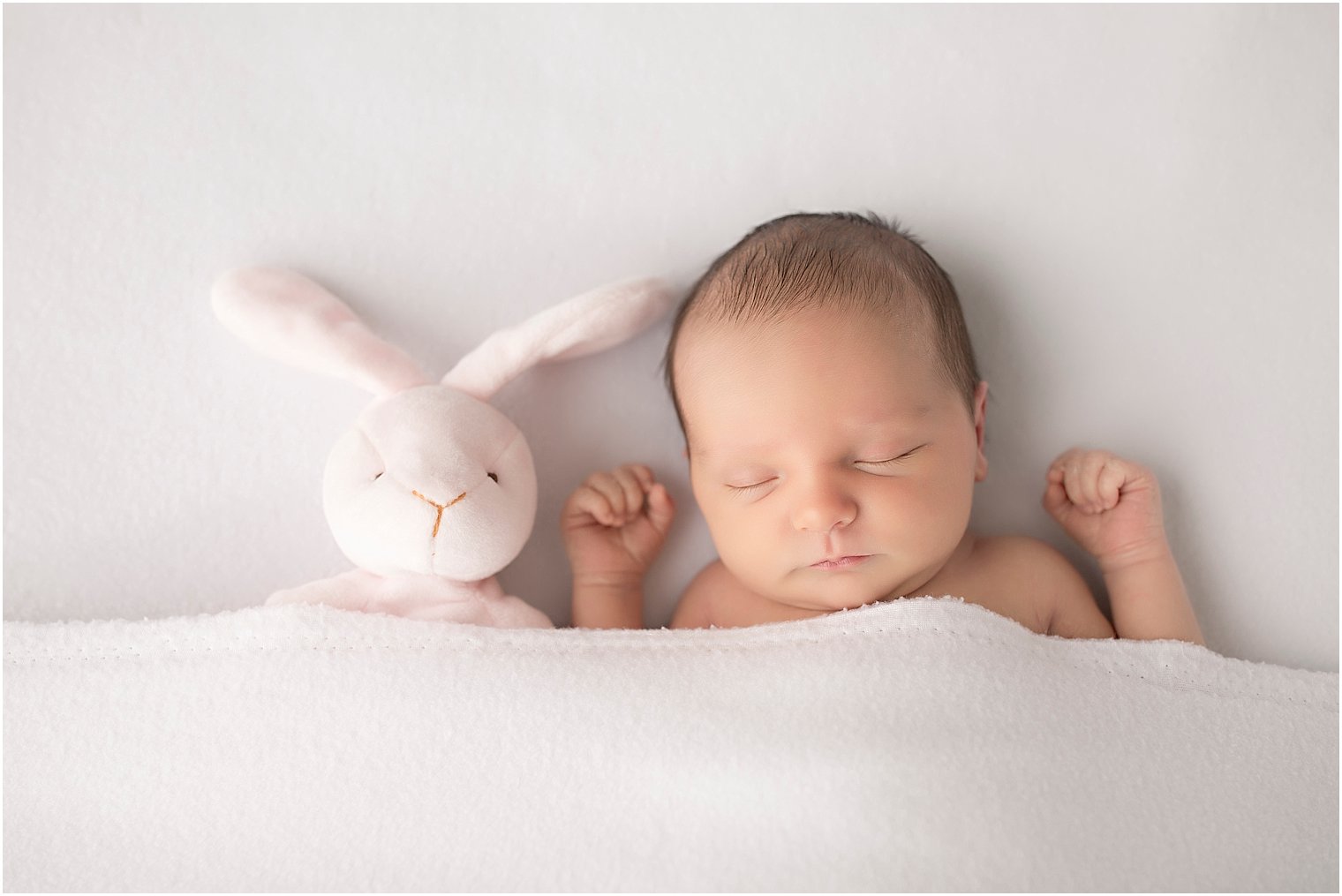 Sleeping newborn girl with bunny