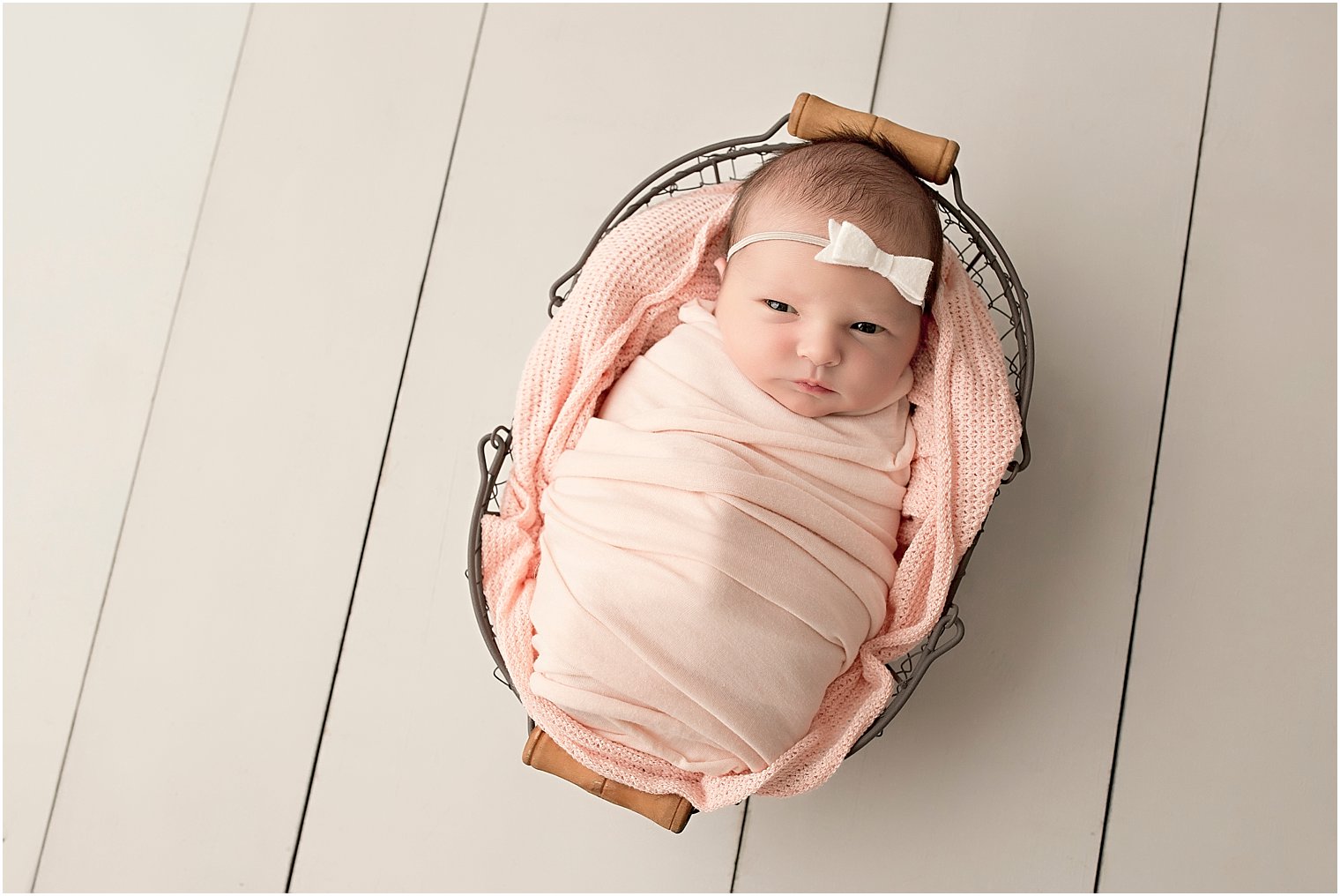 Newborn baby girl in a basket