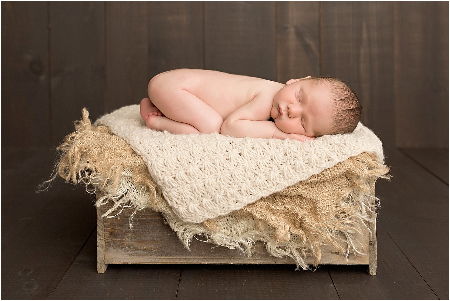 Baby boy on wooden crate