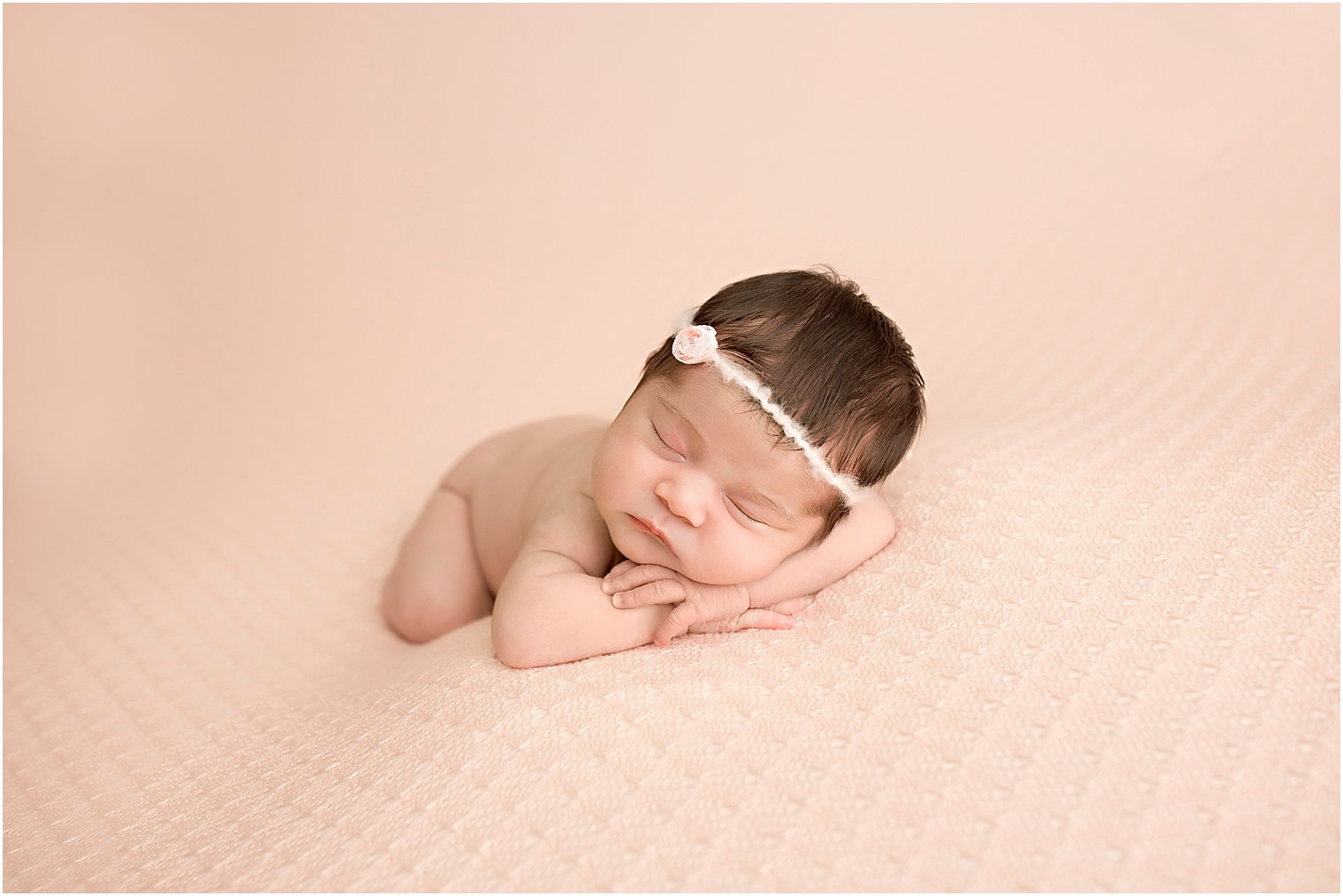 Baby girl on pink blanket