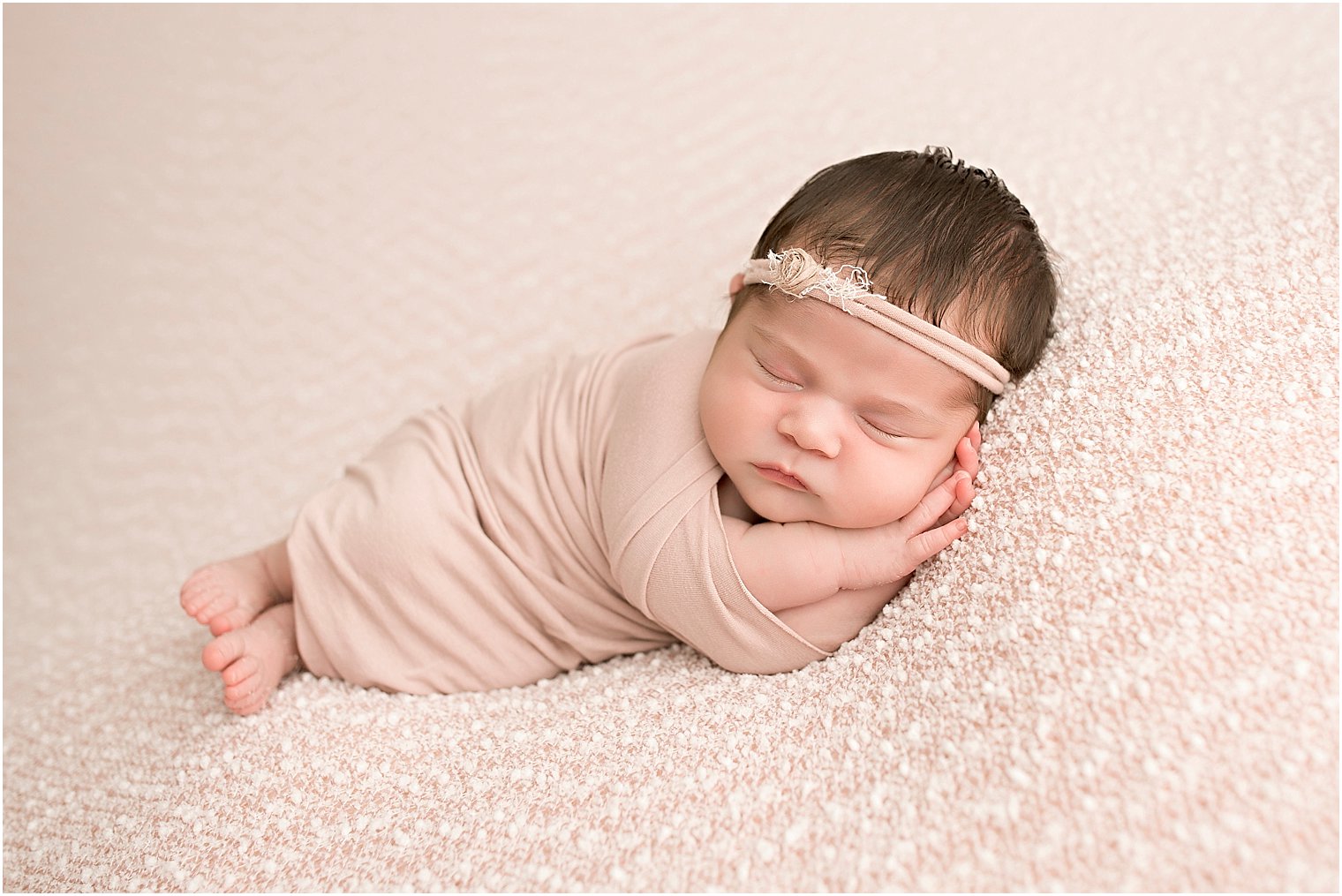 Newborn girl on pink blanket