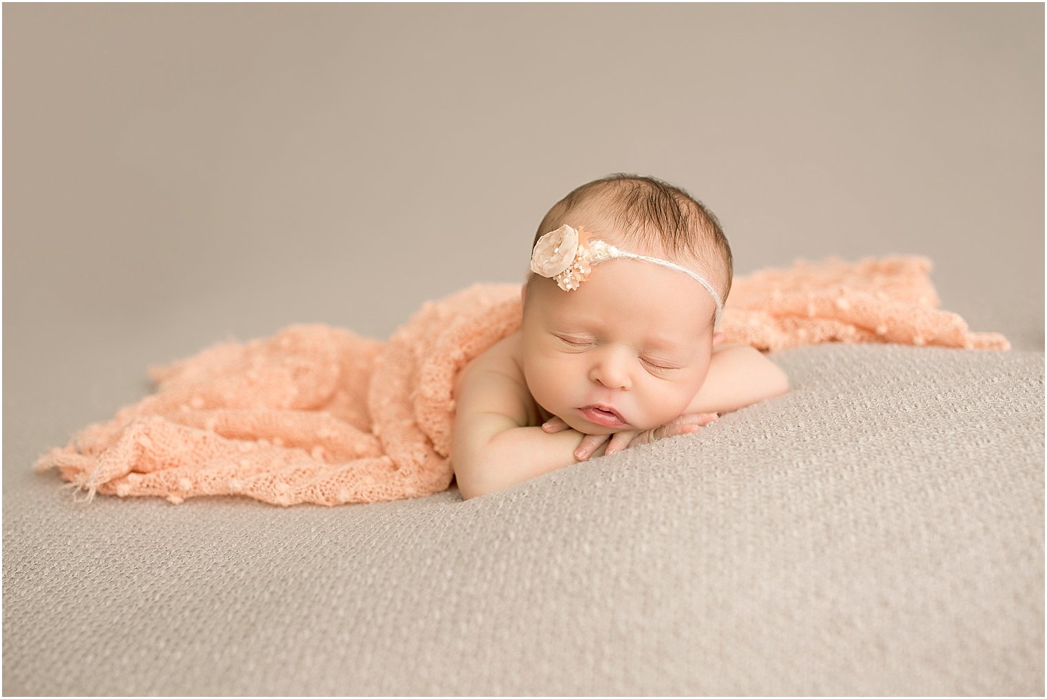 Baby in peach throw and headband