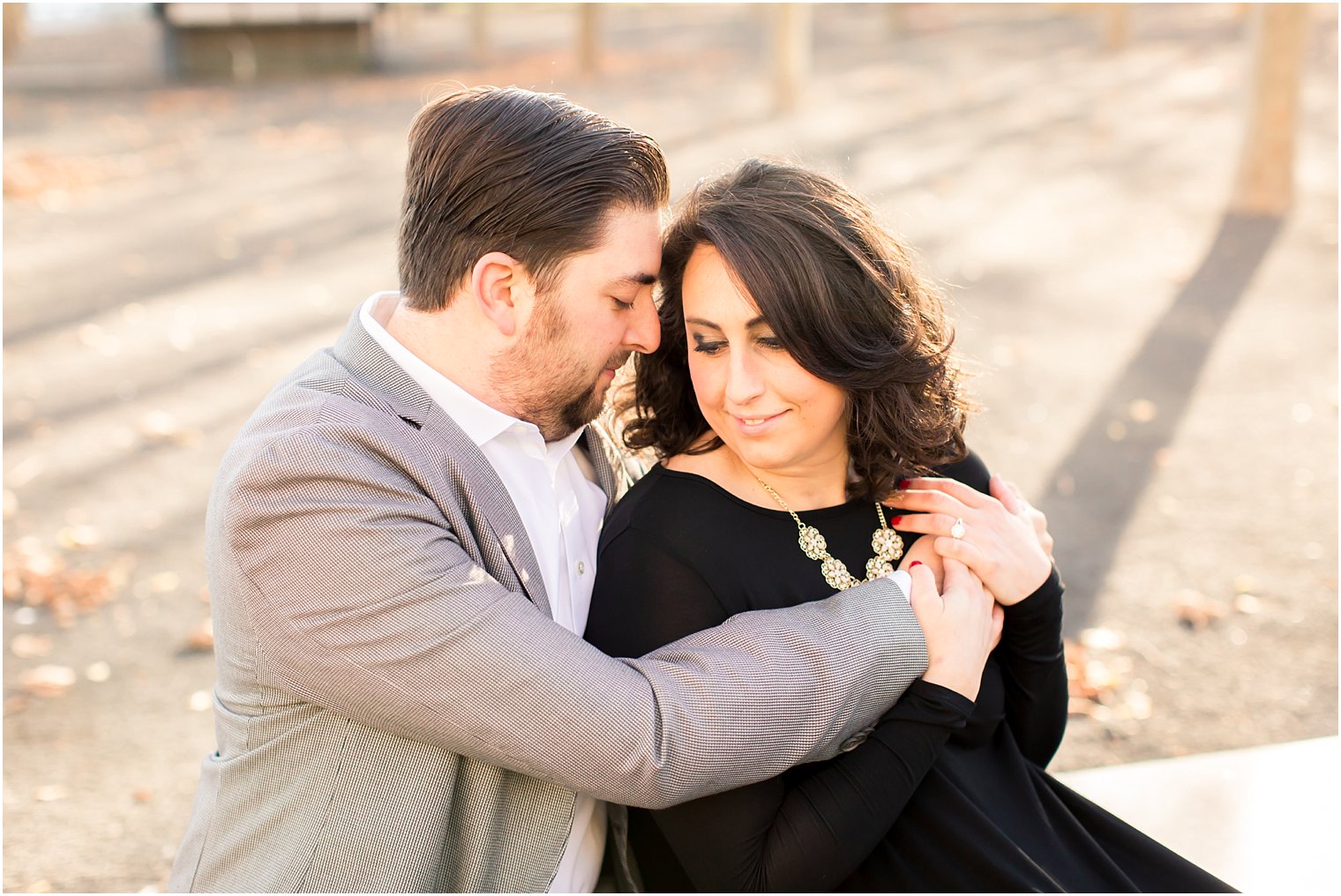 Gray suit and black dress for engagement photos
